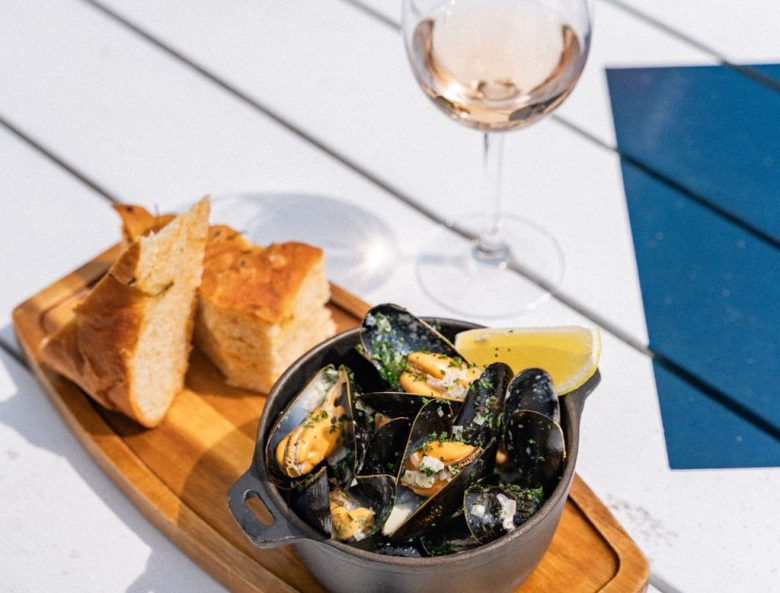 bowl of mussels with glass of rose